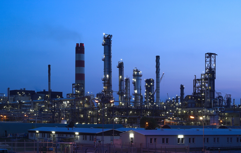 Illuminated oil refinery at twilight